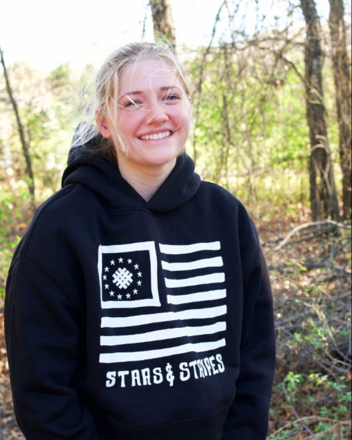 women wearing a black hoodie with a flag design Stars and Stripes